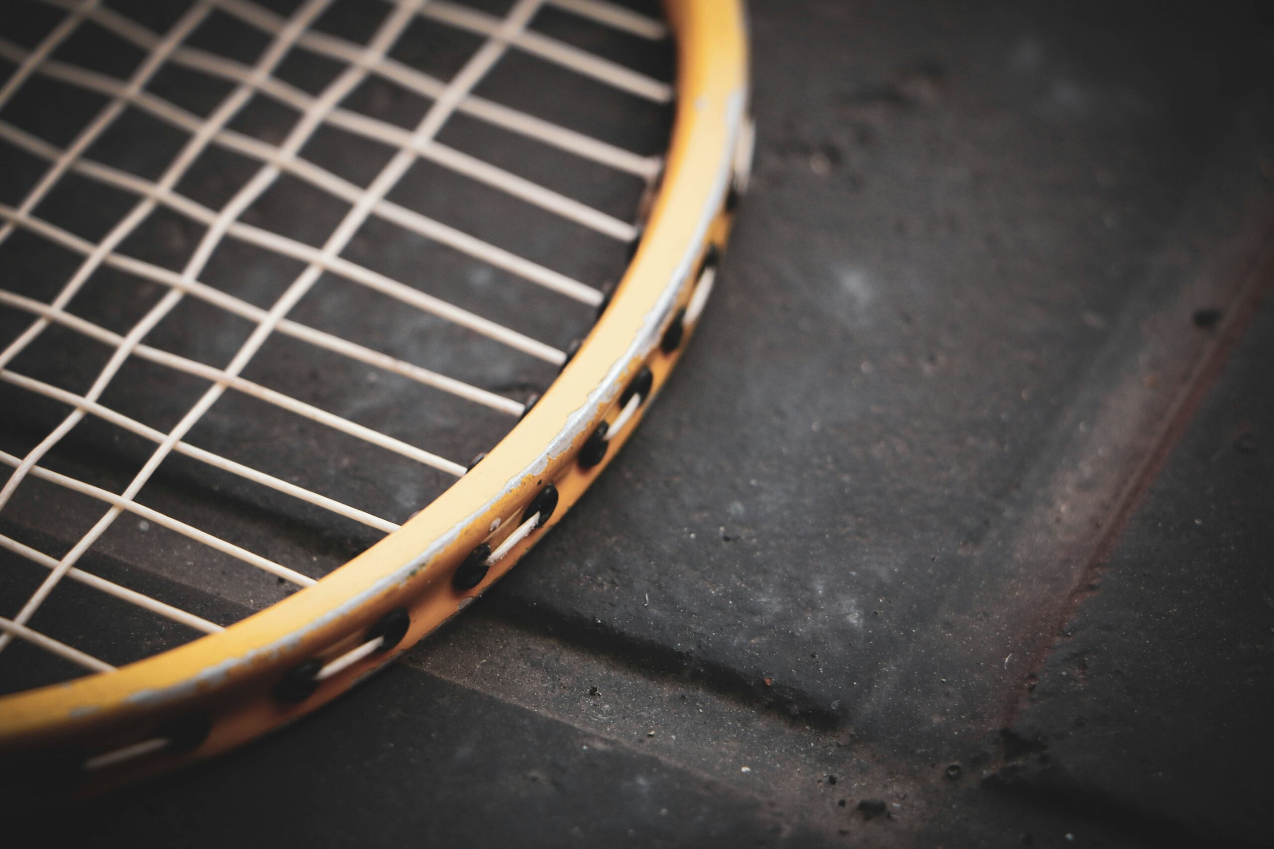 a close up of a tennis racket on a surface